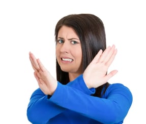 Closeup portrait of angry young woman with X gesture to stop talking, cut it out, dont go there, isolated on white background
